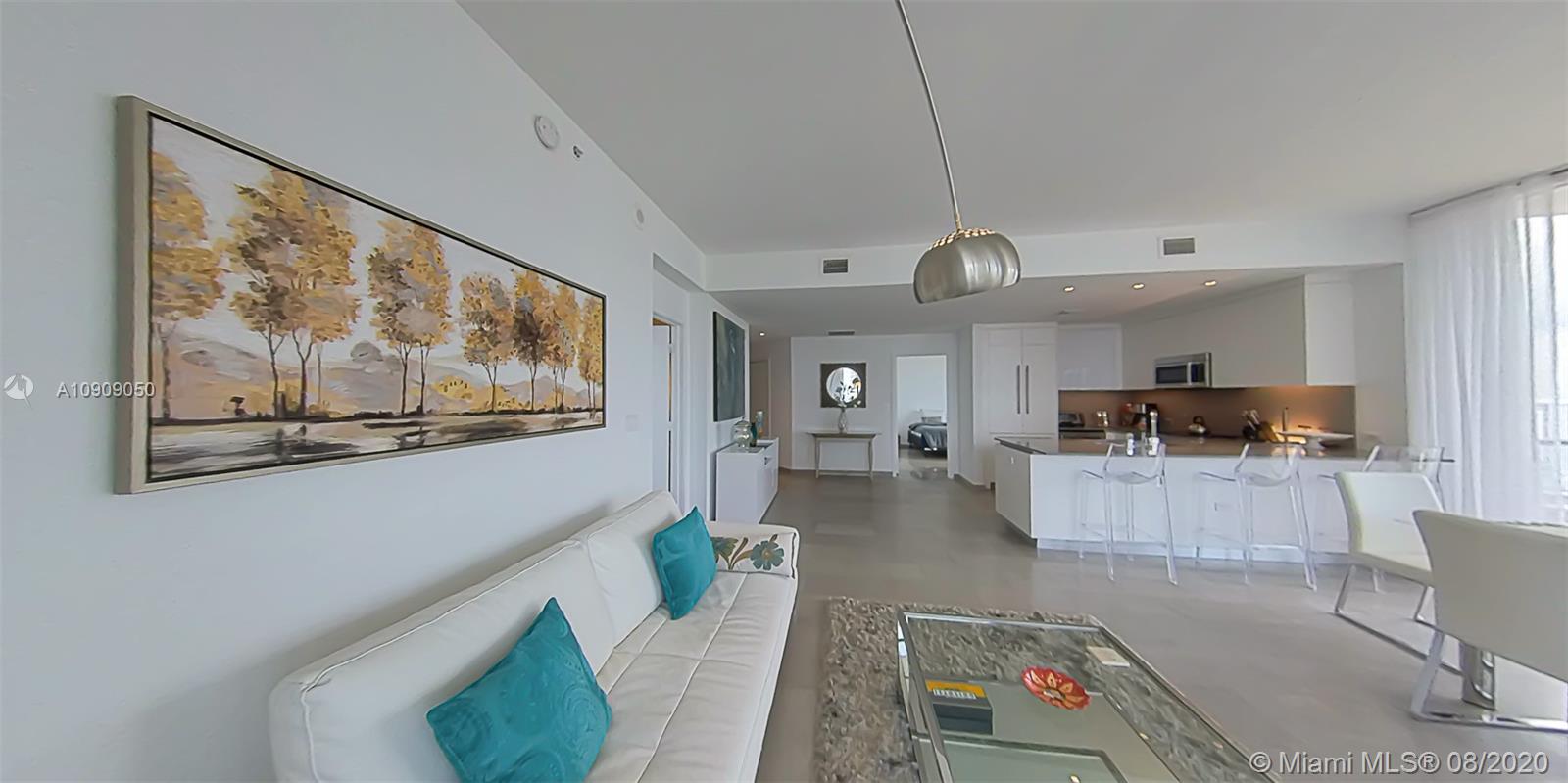 88 Southwest 7th Street, Unit 2911 Miami, FL 33130 - Photo 9 of 25 a living room with furniture and kitchen view