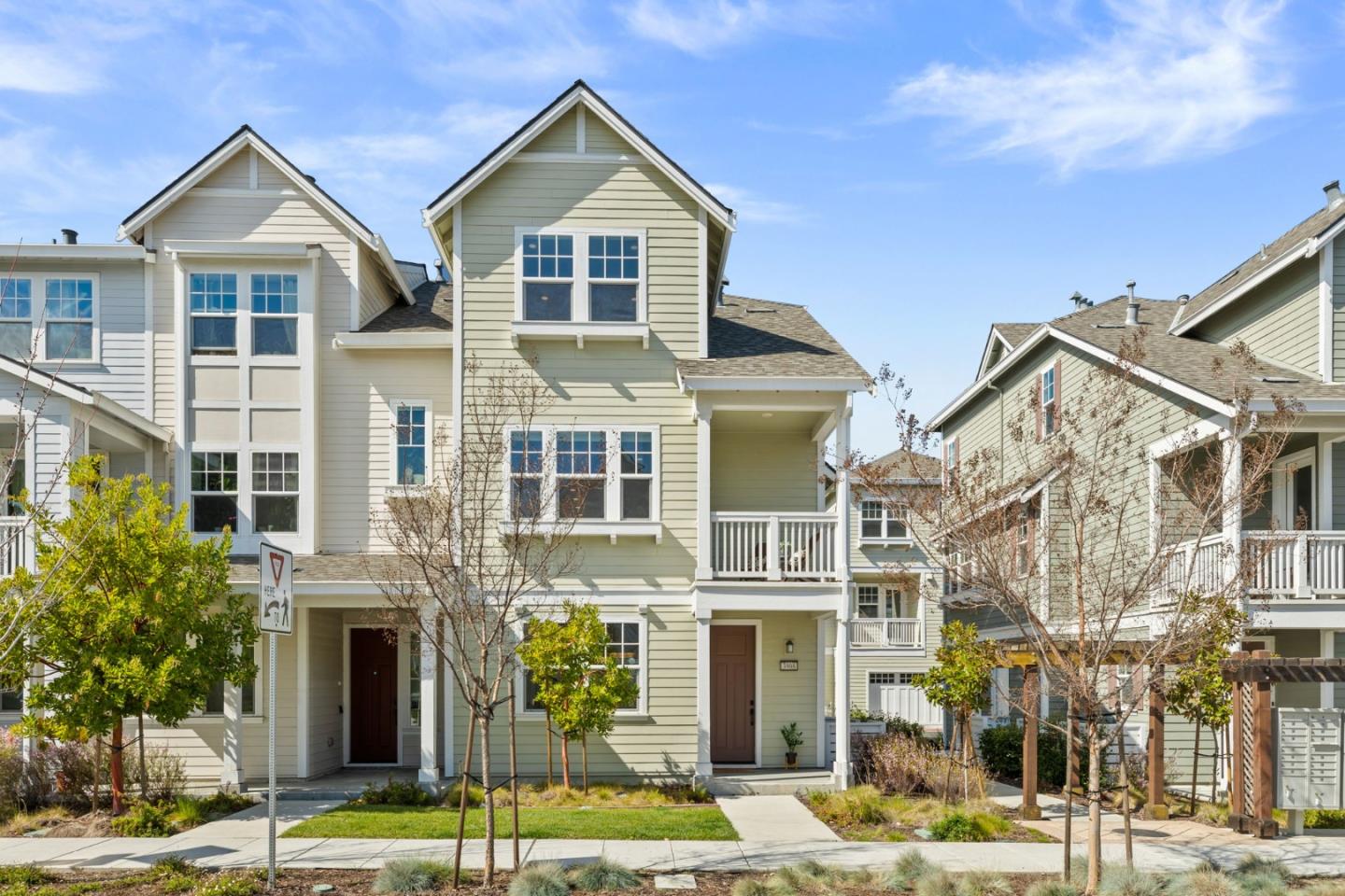 a front view of a residential apartment building with a yard