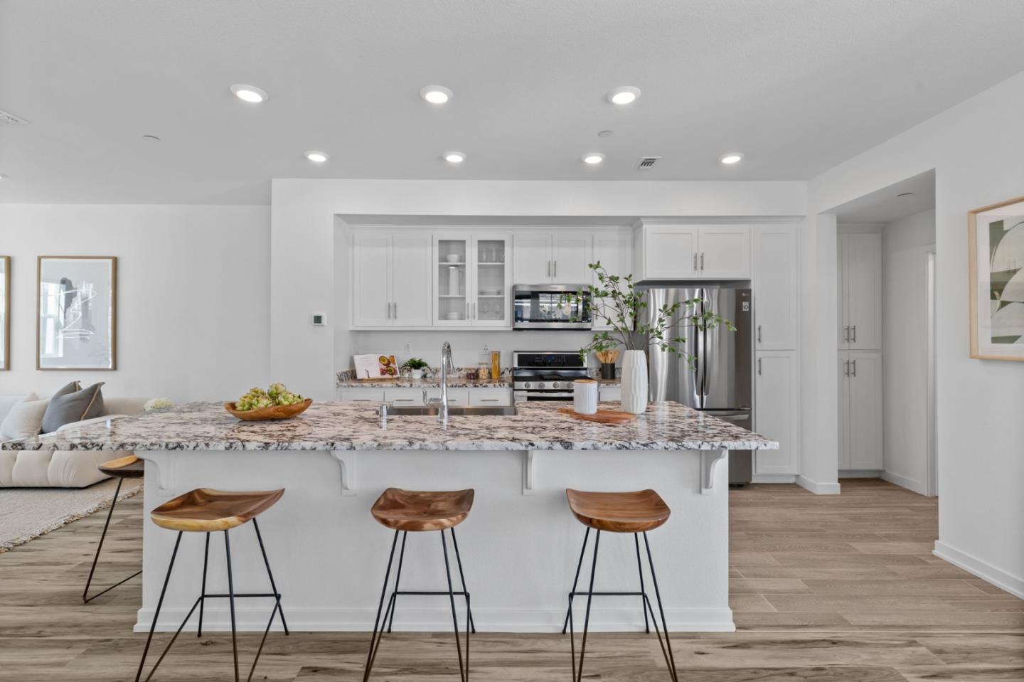 3908 Degree Lane Mountain View, CA 94043 - Photo 7 of 32 a kitchen with stainless steel appliances granite countertop a stove a sink and white cabinets with wooden floor