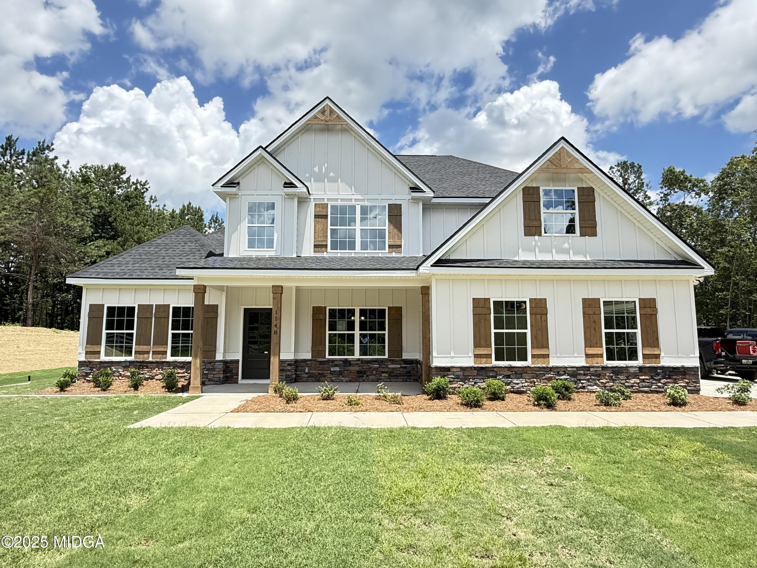 1148 Teagle Road, Unit 4 Forsyth, GA 31029 - Photo 1 of 1 a front view of house with yard and outdoor seating