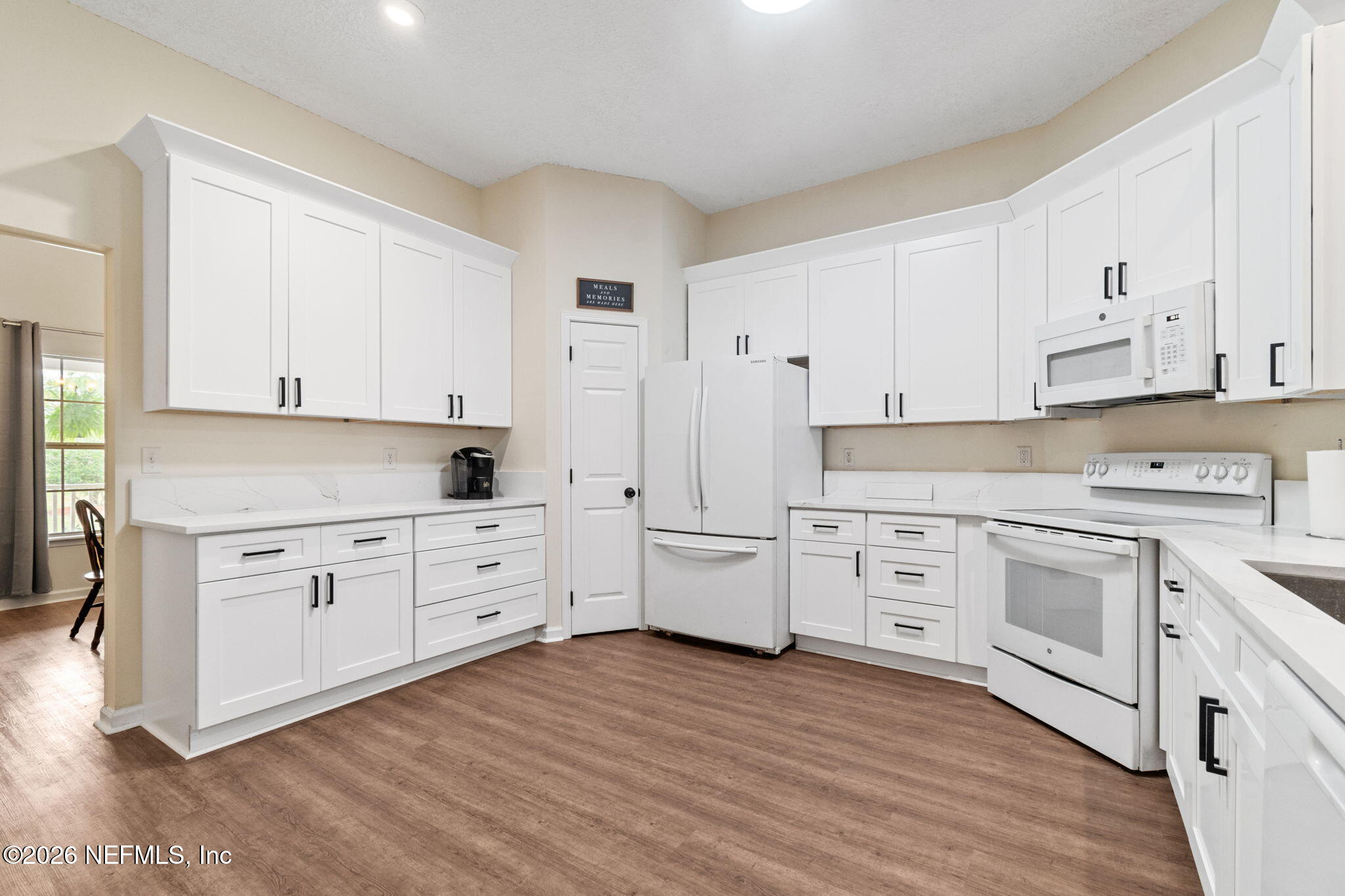 10293 Ford Road Bryceville, FL 32009 - Photo 17 of 63 a kitchen with white cabinets white stainless steel appliances and sink