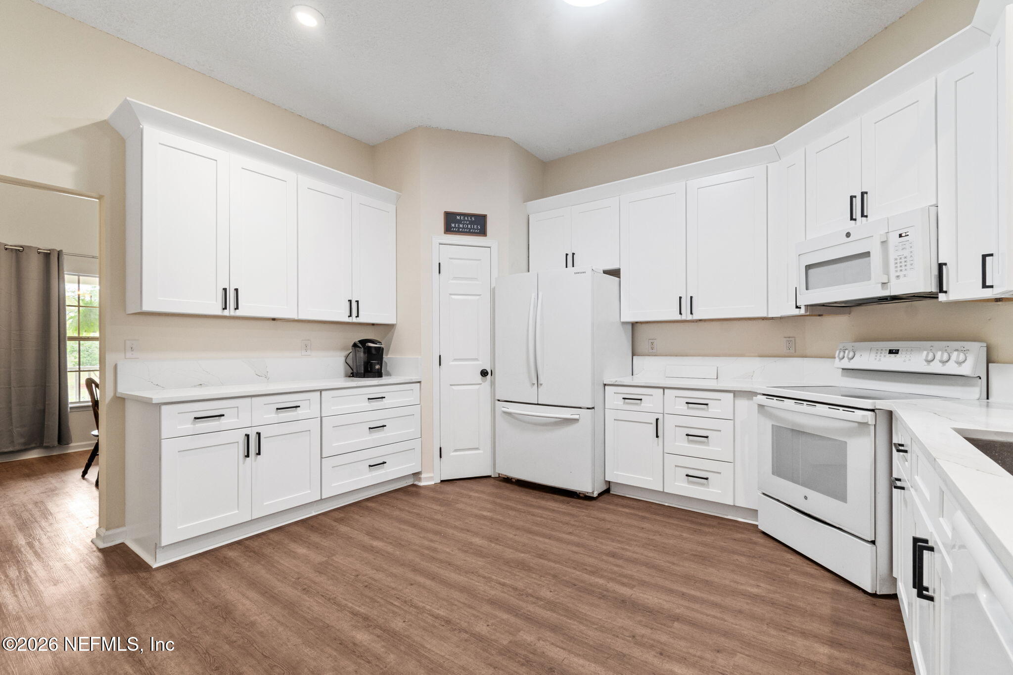 10293 Ford Road Bryceville, FL 32009 - Photo 18 of 63 a kitchen with white cabinets white stainless steel appliances and sink