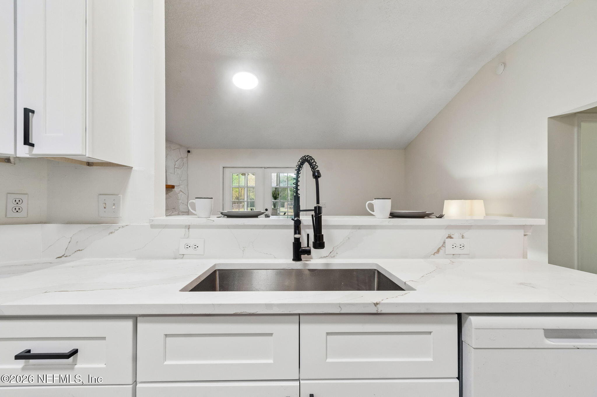 10293 Ford Road Bryceville, FL 32009 - Photo 19 of 63 a kitchen with a sink and white cabinets