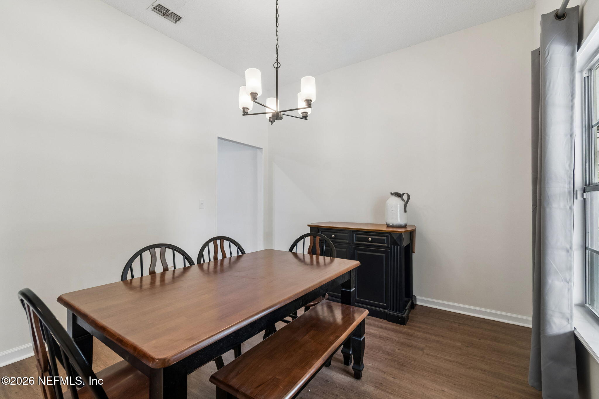 10293 Ford Road Bryceville, FL 32009 - Photo 22 of 63 a view of a dining room with furniture and wooden floor