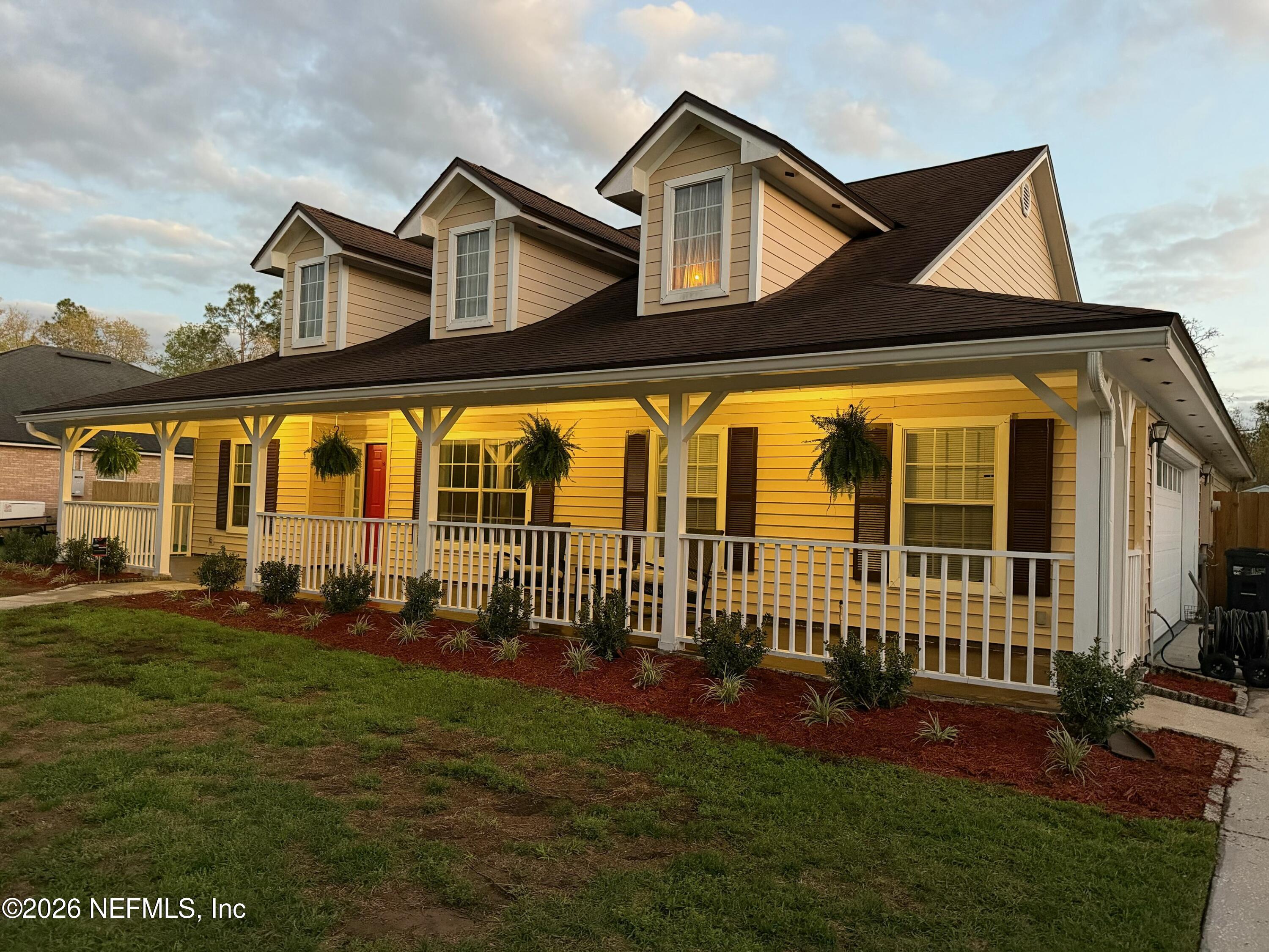 10293 Ford Road Bryceville, FL 32009 - Photo 3 of 63 a front view of a house with a yard table and chairs