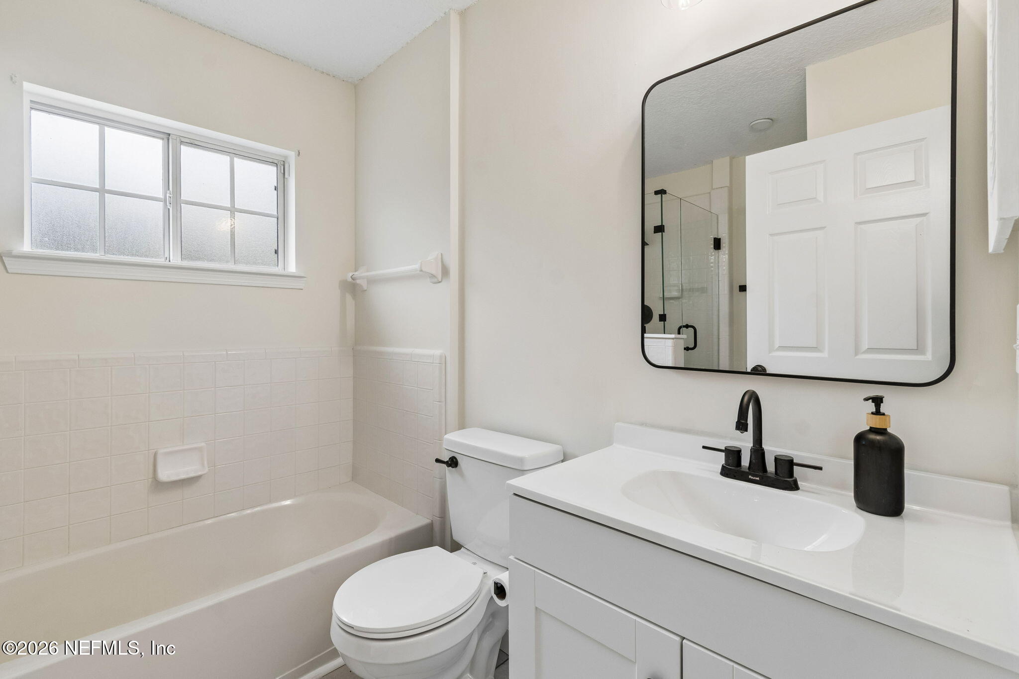 10293 Ford Road Bryceville, FL 32009 - Photo 35 of 63 a bathroom with a sink a toilet and a mirror