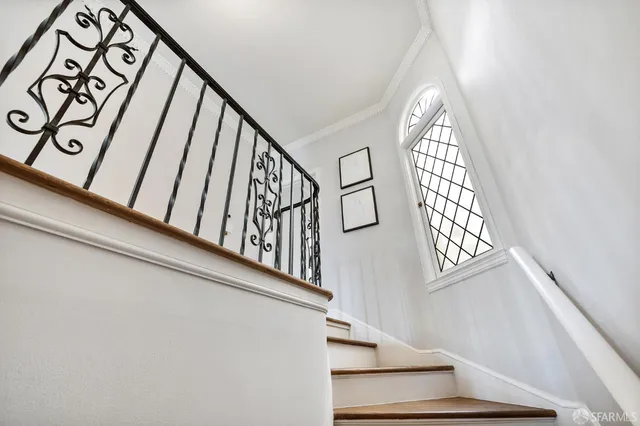 a living room with a fireplace and a potted plant