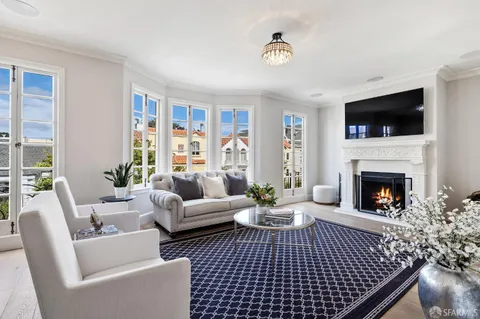 a living room with a fireplace and a flat screen tv