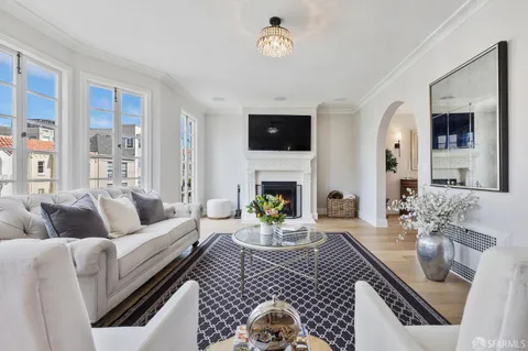 a dining room with furniture a chandelier and wooden floor