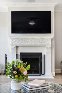 a view of a dining room with furniture a chandelier and wooden floor