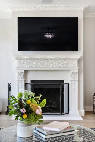 a view of a dining room with furniture a chandelier and wooden floor