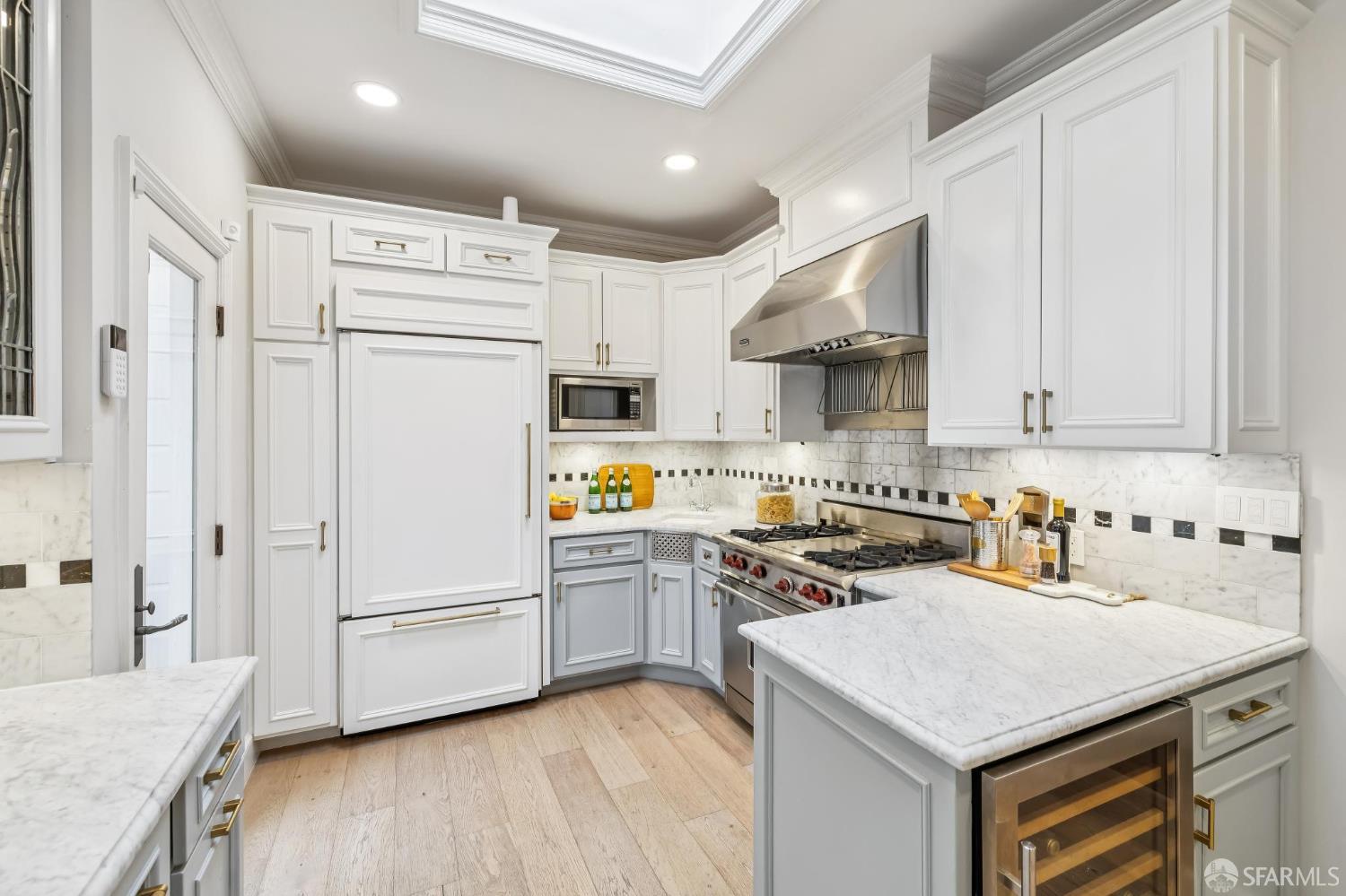 3641 Webster Street San Francisco, CA 94123 - Photo 25 of 52 a kitchen with stainless steel appliances a white refrigerator a sink a stove and white cabinets