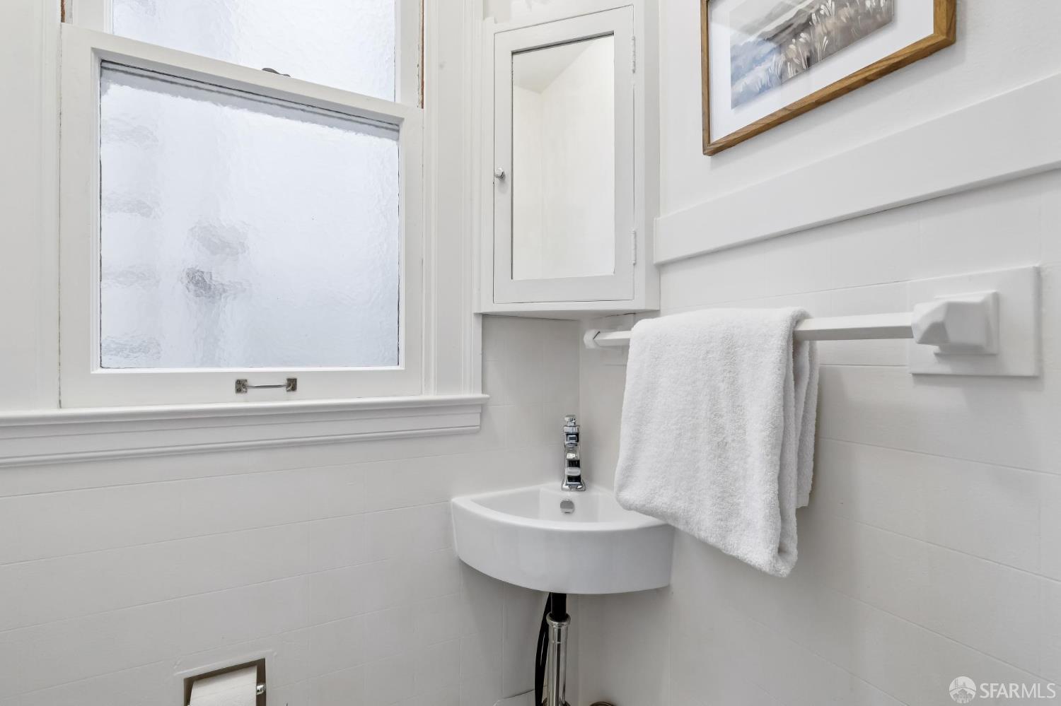 3641 Webster Street San Francisco, CA 94123 - Photo 41 of 52 a bathroom with a sink and a mirror