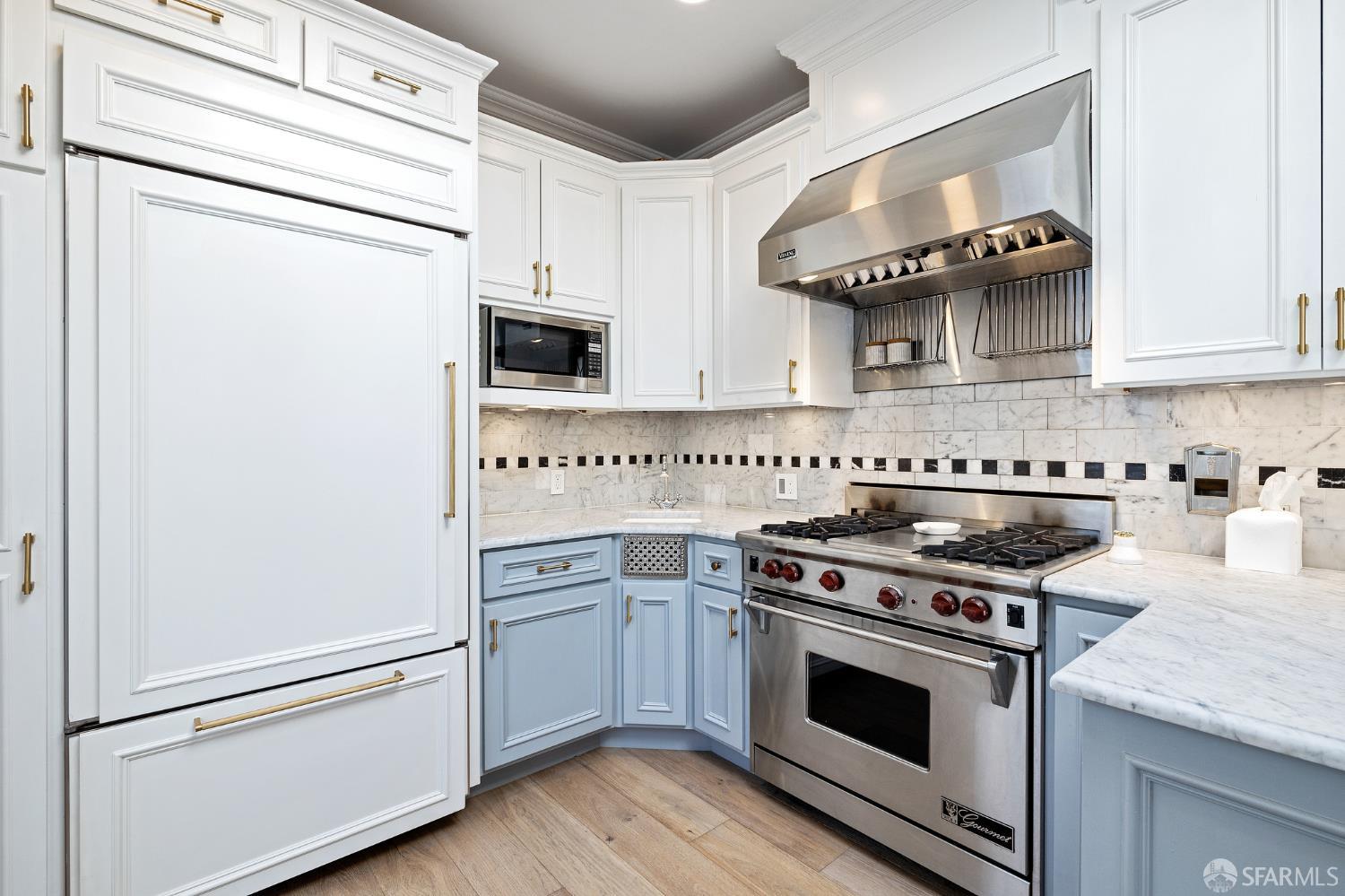 Webster Street San Francisco, CA 94123 - Photo 48 of 83 a kitchen with granite countertop cabinets stainless steel appliances and wooden floor