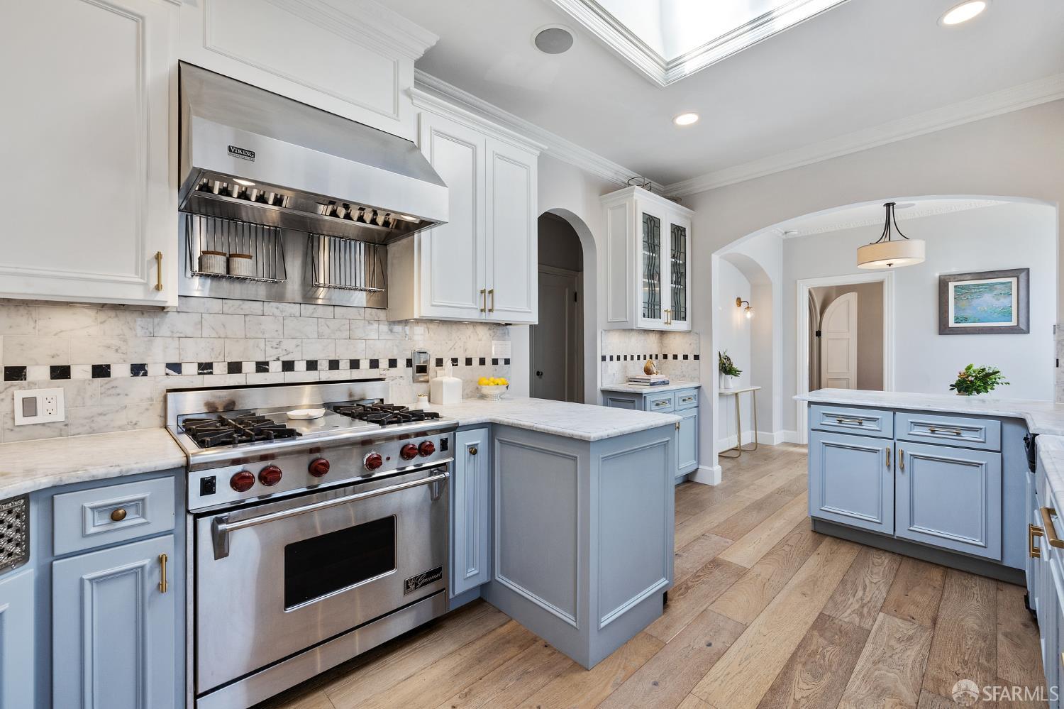 Webster Street San Francisco, CA 94123 - Photo 50 of 83 a kitchen with stainless steel appliances granite countertop a stove and white cabinets