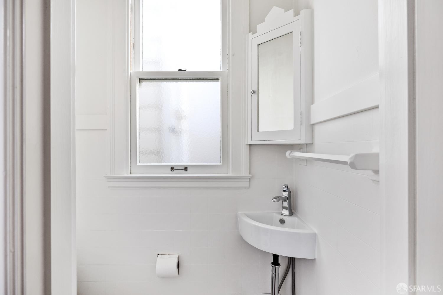 Webster Street San Francisco, CA 94123 - Photo 67 of 83 a bathroom with a sink a mirror and a window