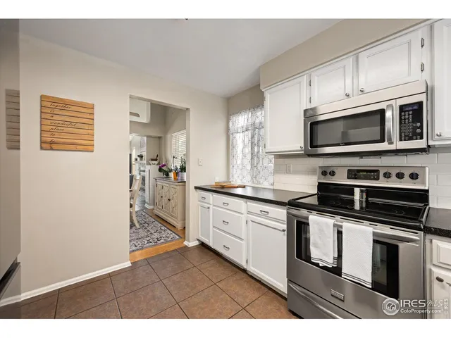 a kitchen with stainless steel appliances granite countertop a stove microwave and sink