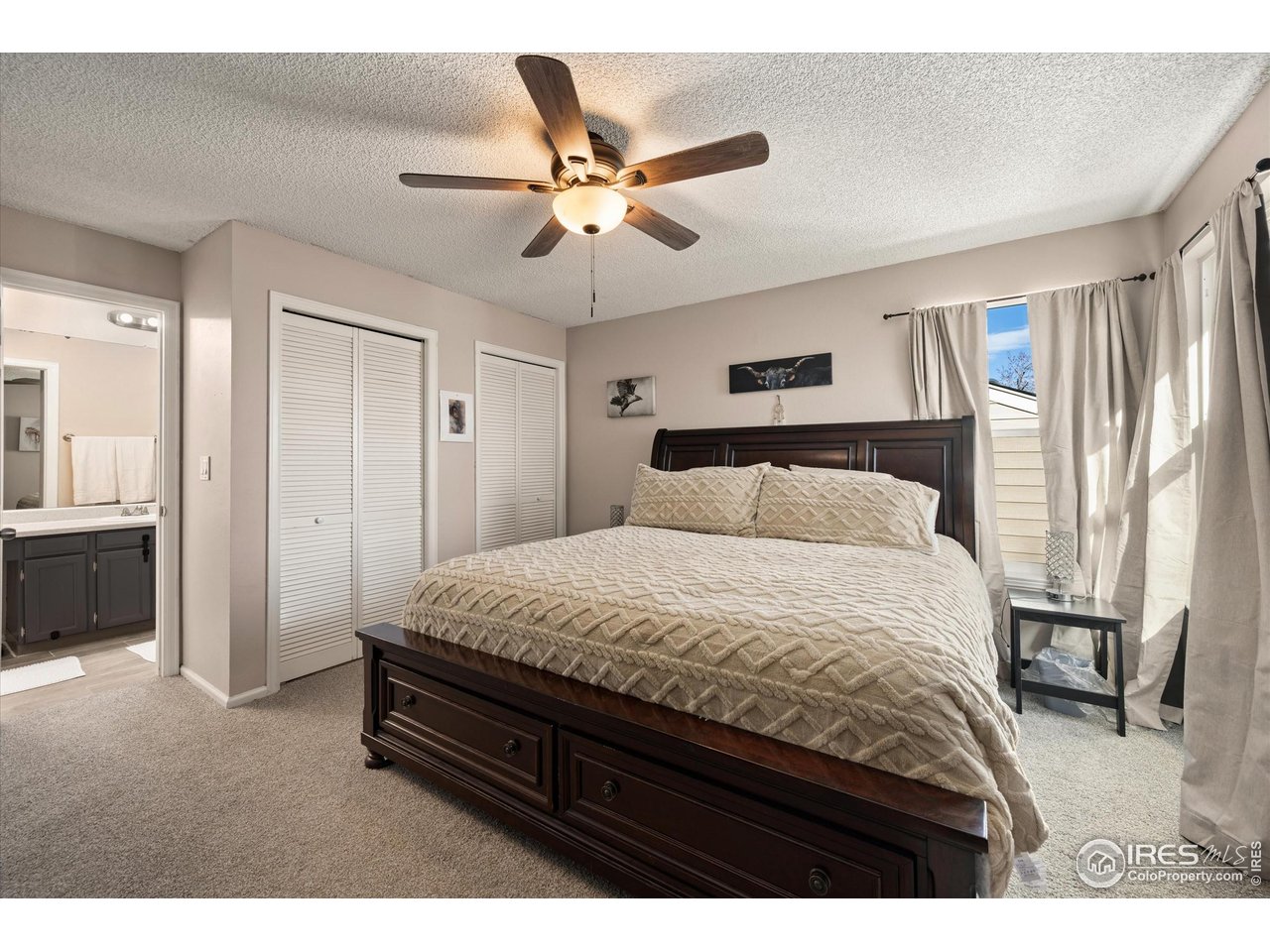 7328 South Gore Range Road Littleton, CO 80127 - Photo 15 of 38 a bedroom with a bed and a chandelier