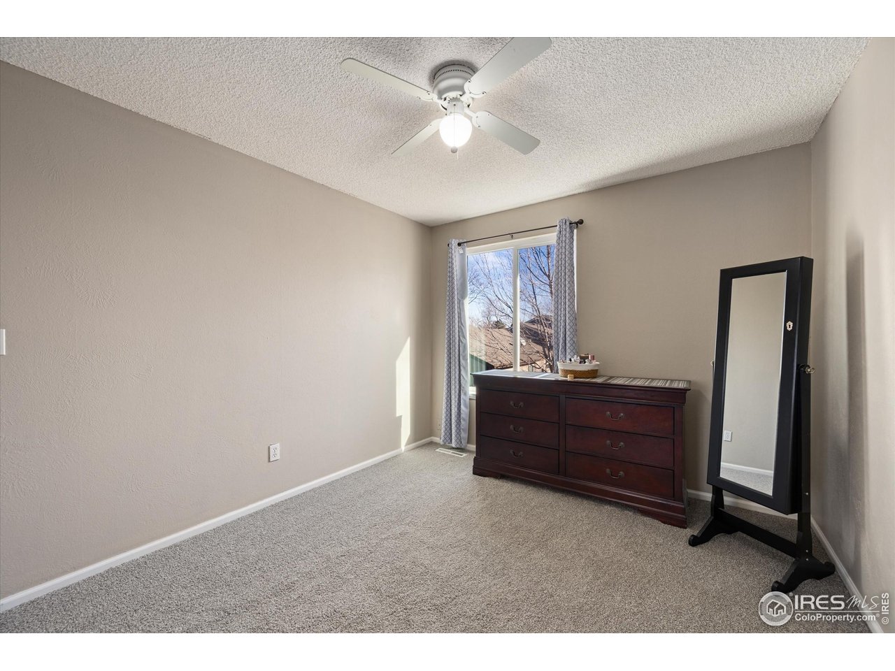 7328 South Gore Range Road Littleton, CO 80127 - Photo 18 of 38 a bed room with a bed and a window