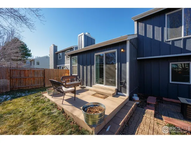 a view of backyard with furniture and a yard