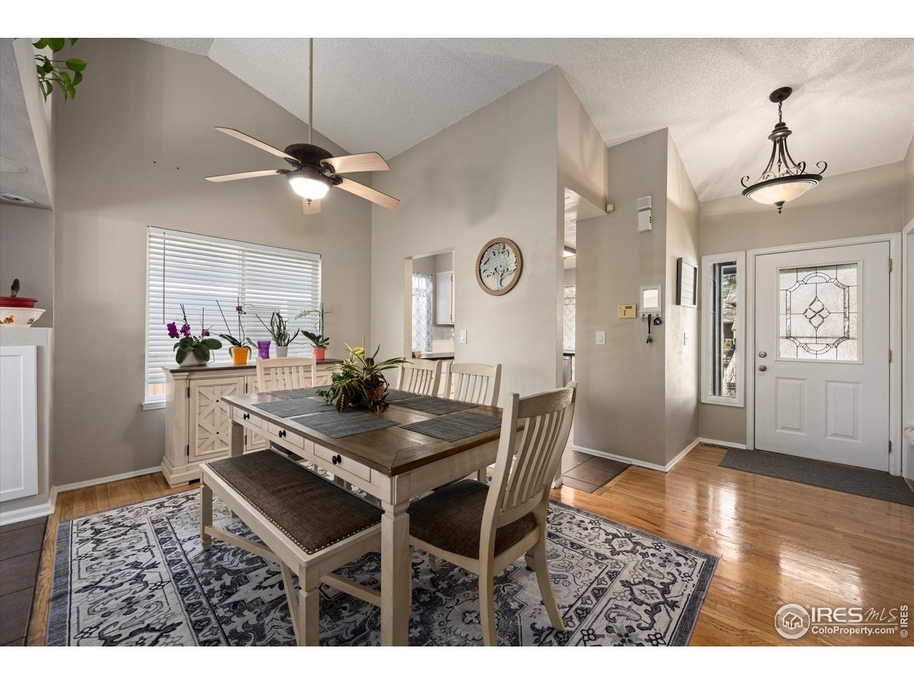 7328 South Gore Range Road Littleton, CO 80127 - Photo 6 of 38 a view of a dining room with furniture and wooden floor