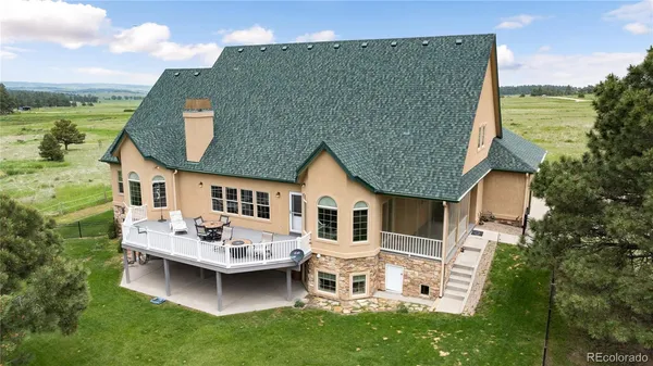 a view of a house with a chairs in patio