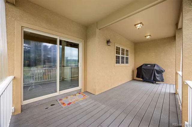 a hallway with couches and wooden floor
