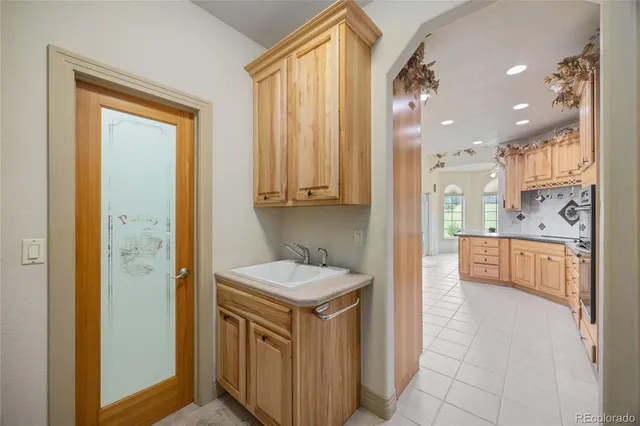 a bathroom with a granite countertop sink a mirror and a bathtub
