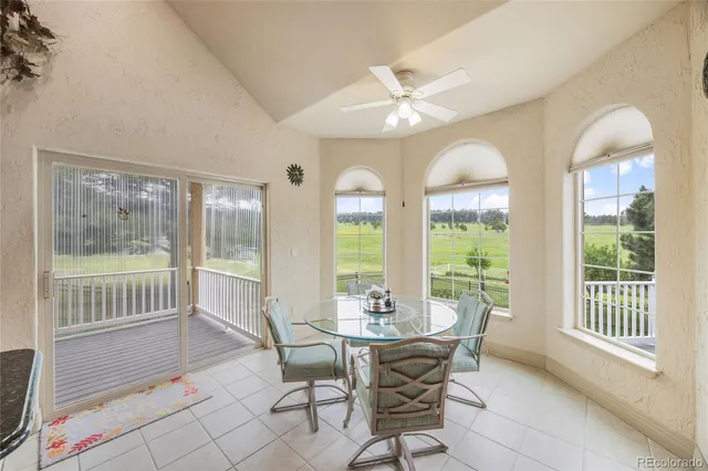 a dining room with furniture a chandelier and wooden floor