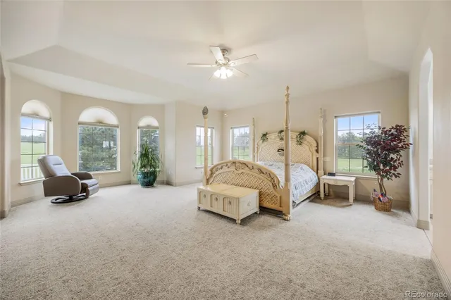 a spacious bedroom with a bed and a large window