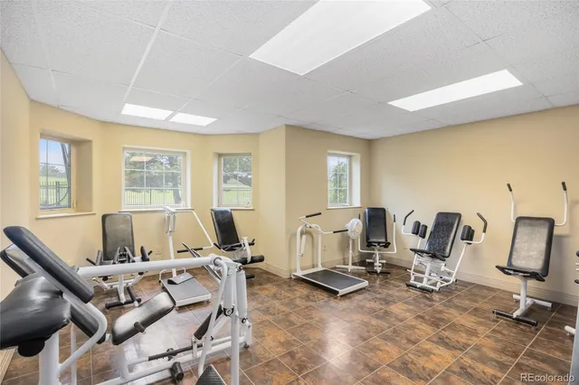 a living room with furniture and floor to ceiling window