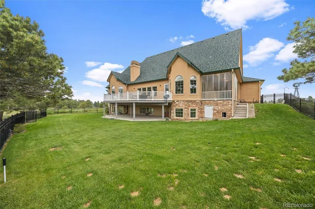 a view of a house with a big yard potted plants and large tree