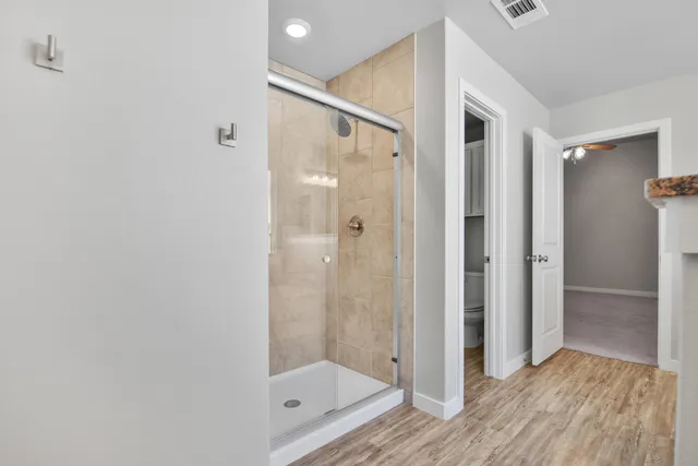 a bathroom with a glass shower door