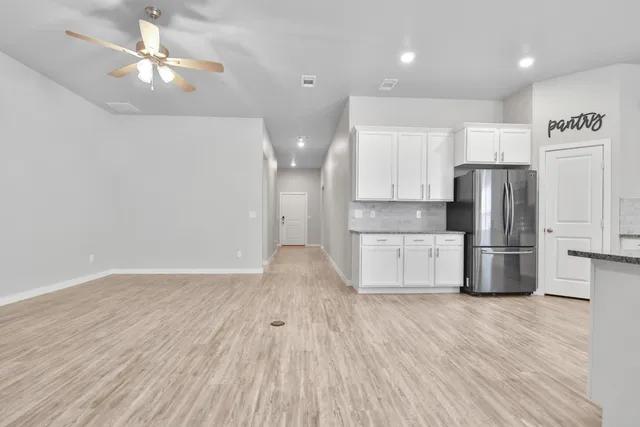 a kitchen with stainless steel appliances a refrigerator sink and cabinets