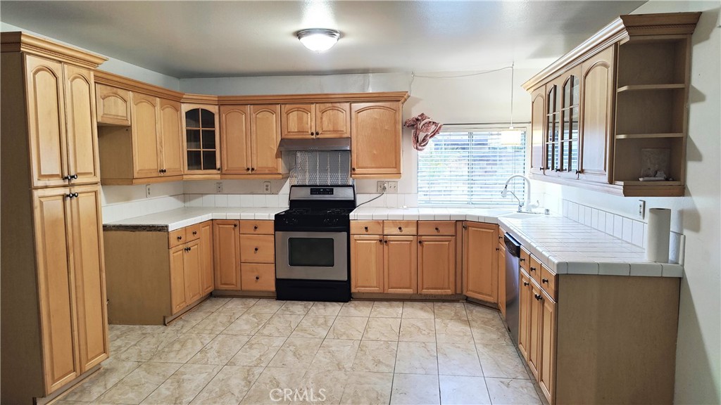2821 Greenleaf Drive West Covina, CA 91792 - Photo 11 of 32 a kitchen with a stove sink and cabinets
