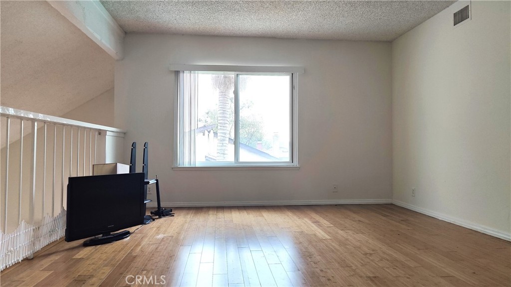 2821 Greenleaf Drive West Covina, CA 91792 - Photo 18 of 32 an empty room with wooden floor and windows