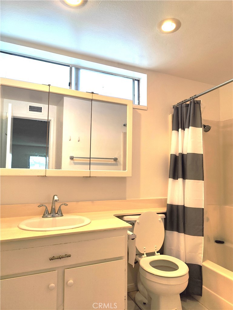 2821 Greenleaf Drive West Covina, CA 91792 - Photo 24 of 32 a bathroom with a granite countertop sink mirror vanity and toilet