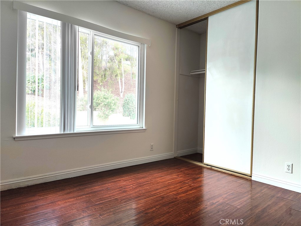 2821 Greenleaf Drive West Covina, CA 91792 - Photo 27 of 32 an empty room with wooden floor and windows