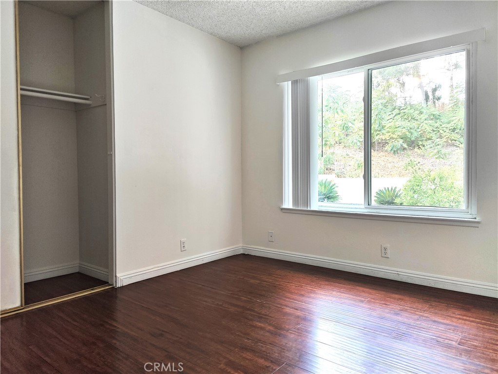 2821 Greenleaf Drive West Covina, CA 91792 - Photo 28 of 32 an empty room with wooden floor and windows