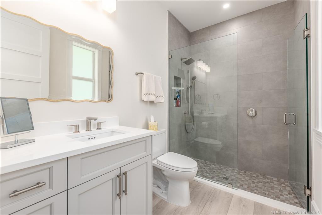 1879 Northwest River Trail Stuart, FL 34994 - Photo 16 of 25 a bathroom with a sink a toilet and shower