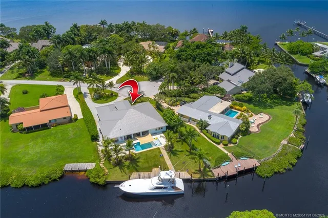 an aerial view of a house with outdoor space and a lake view