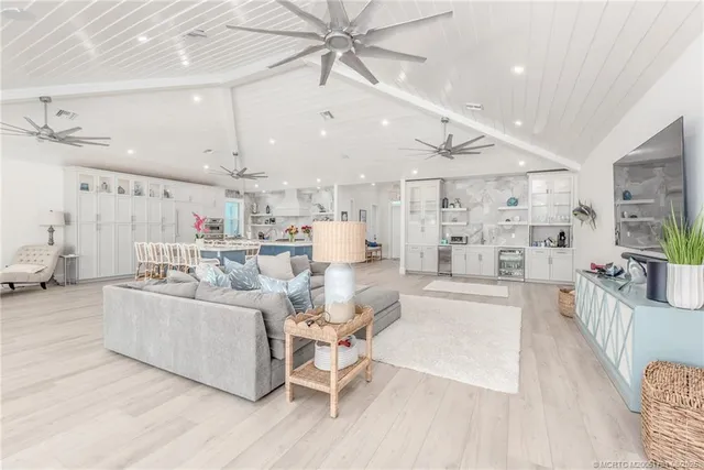 a living room with furniture and a kitchen view