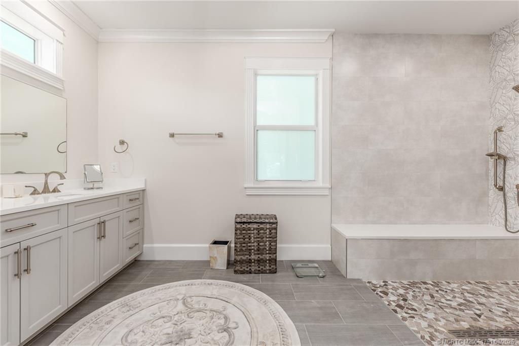 1879 Northwest River Trail Stuart, FL 34994 - Photo 9 of 25 a spacious bathroom with a bathtub sink and mirror