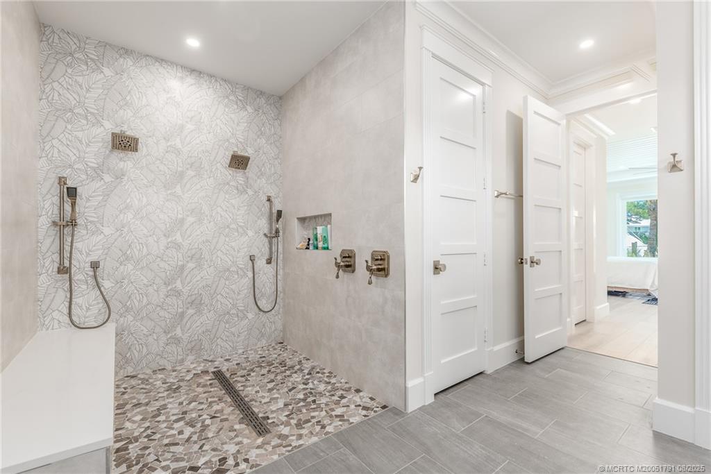 1879 Northwest River Trail Stuart, FL 34994 - Photo 10 of 25 a bathroom with a glass shower door