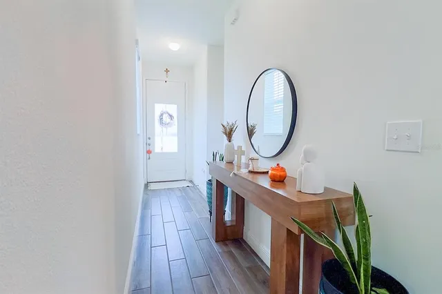 a kitchen with microwave a refrigerator and chairs