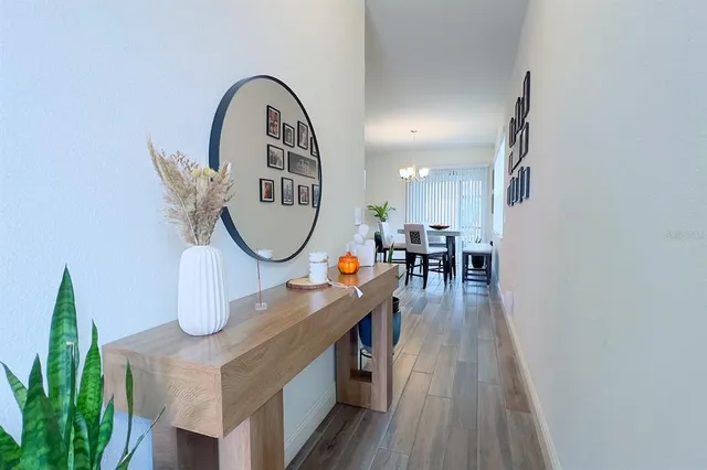 a kitchen with granite countertop a refrigerator cabinets and wooden floor