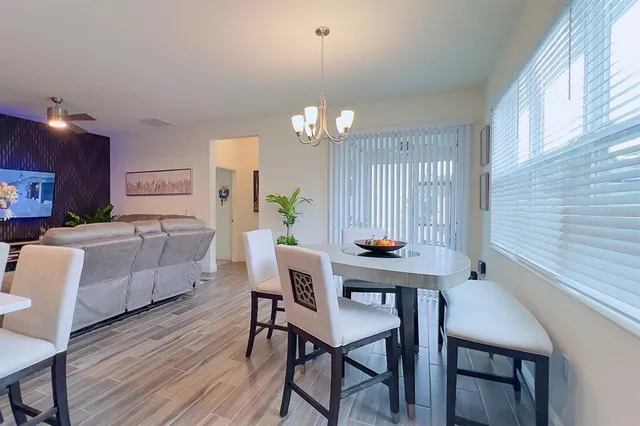 a kitchen with stainless steel appliances kitchen island granite countertop a sink refrigerator and cabinets