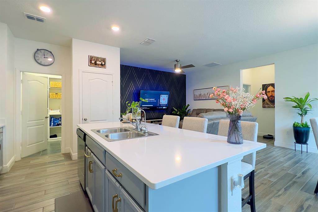 2755 Mdw Strm Way Clermont, FL 34714 - Photo 21 of 64 a kitchen with stainless steel appliances kitchen island granite countertop a sink refrigerator and cabinets