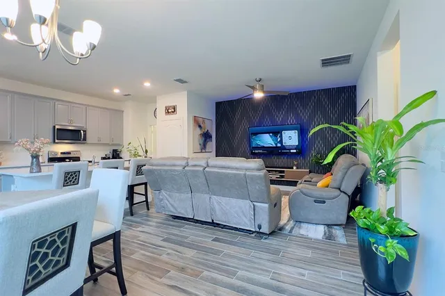 a living room with furniture and a potted plant