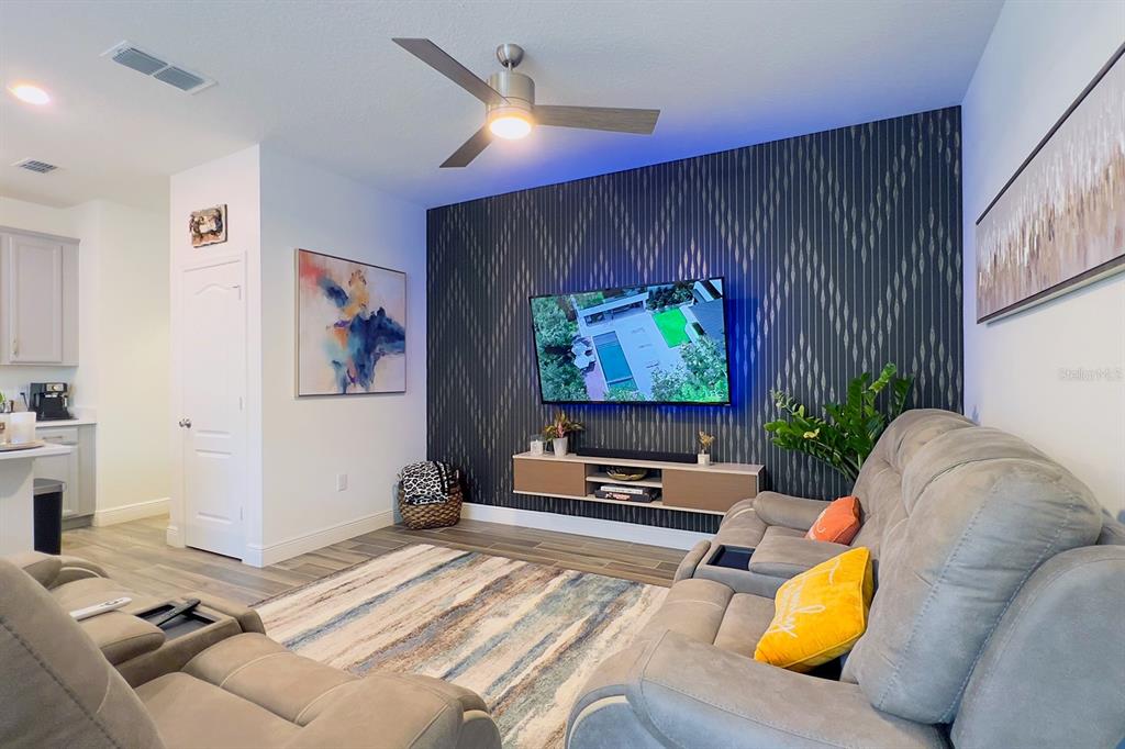 2755 Mdw Strm Way Clermont, FL 34714 - Photo 25 of 64 a living room with furniture and a flat screen tv